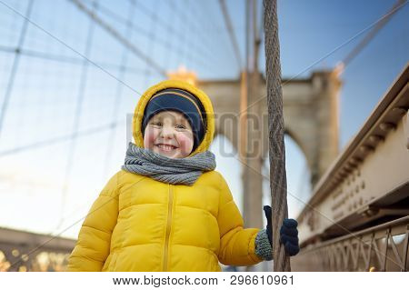 Cute Little Boy On Brooklyn Bridge With Skyscrapers On Background. Family Travel With Children.