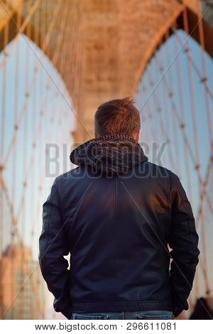 Man On A Famous Brooklyn Bridge By Sunsets. Landmarks Of New York City, Usa.