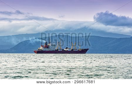 The Fishing Boat In Gray Morning On Pacific Ocean Off The Coast Of The Kamchatka Peninsula