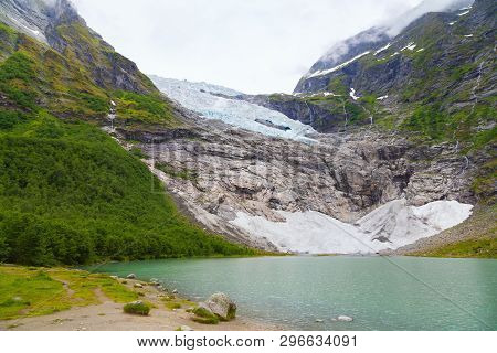 Landscape With River Near Briksdal Or Briksdalsbreen Glacier In Olden, Norway With Green Mountain. N