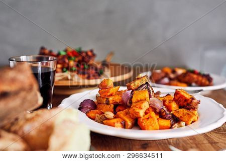Low Angle View Of Table Served With Traditional British Sunday Roast Dinner, Featuring Roasted Chick