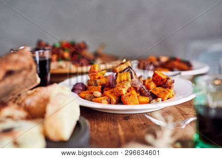 Low Angle View Of Table Served With Traditional British Sunday Roast Dinner, Featuring Roasted Chick