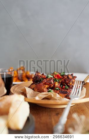 Low Angle View Of Table Served With Traditional British Sunday Roast Dinner, Featuring Roasted Chick