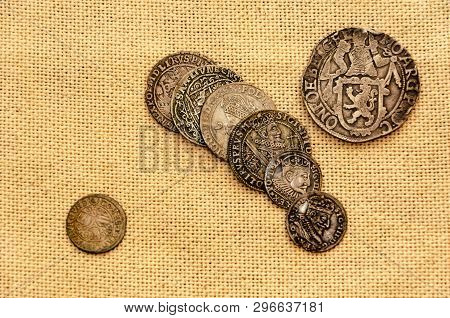Pail Of Thalers. Old Silver Coins On Linen Background