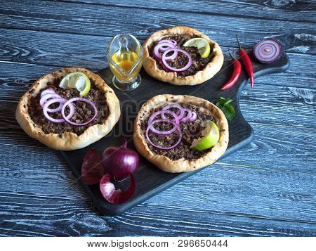 Arabian Opened Meat Pies Sfiha On Wooden Cutting Board. Top View.