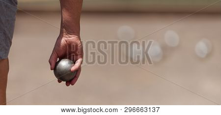 Senior Playing Petanque, Balls On The Ground