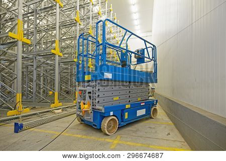 Scissor Lift Aerial Work Platform In Distribution Warehouse