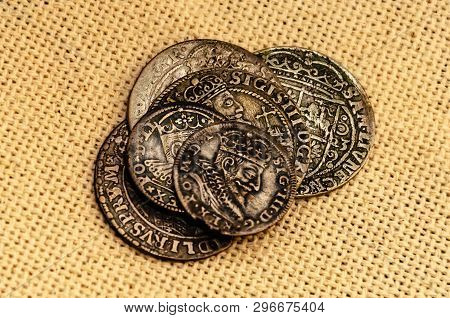 Pail Of Thalers. Old Silver Coins On Linen Background