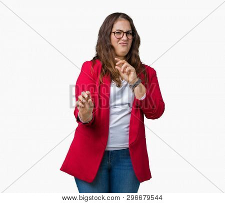 Beautiful plus size young business woman wearing elegant jacket and glasses over isolated background disgusted expression, displeased and fearful doing disgust face because aversion reaction