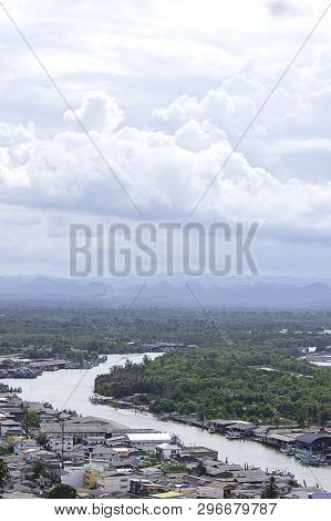 The Point Of View Of Cityscape And A Boat Parked In Tha Taphao River , Background Mountains And  Sky