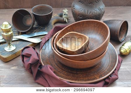 Empty Restaurant Tableware And Napkin Of Grenadine Color. Rustic Wooden Brown Background.