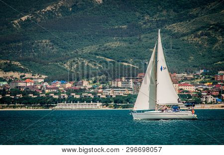 23 May 2018 Gelendgik, Russia. White Sailboat Travelling With Tourists Through The Bay.