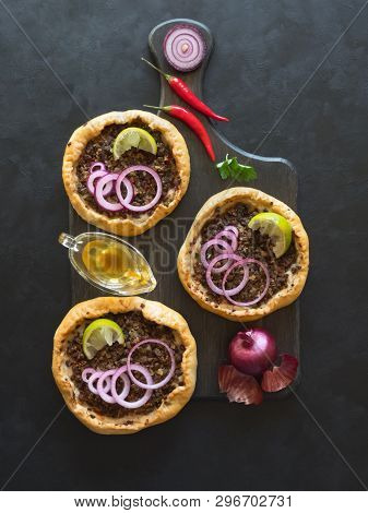 Arabian Opened Meat Pies Sfiha On Wooden Cutting Board. Top View.