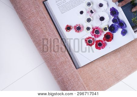Loral Flat Lay With Linen Floral Packaging And A Book About Anemones With Space For Text. Concept Of