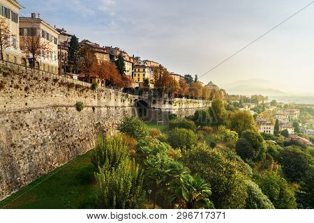 View Of Bergamo City With Sant Andrea Platform Of Venetian Walls At Morning. Italy
