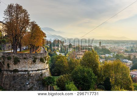 View Of Bergamo City With Sant Andrea Platform Of Venetian Walls At Morning. Italy