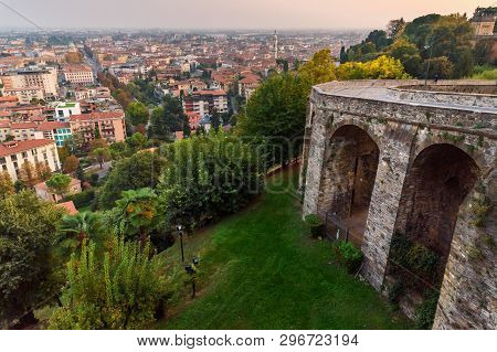 View Of Bergamo City And Old Bridge On Via Sant Alessandro Street To Upper City Cita Alta At Sunset.