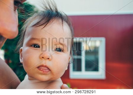 Portrait Of A Newborn Baby With His Tongue Sticking Out