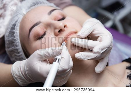 Permanent Makeup For Eyebrows. Microblading Brow. Beautician Doing Eyebrow Tattooing For Female Face
