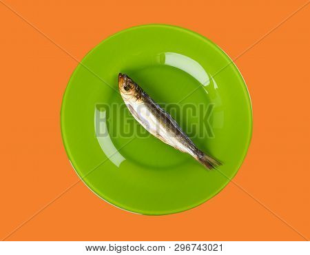 Cold Smoked Baltic Herring On An Green Plate On Orange Background. Smoked Baltic Herring Smoked Unti