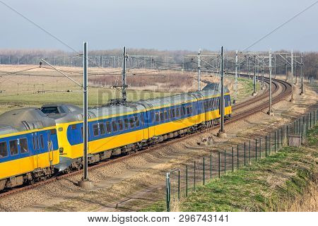 Dutch Railway With Express Train Through National Park Oostvaardersplassen Between Lelystad And Alme