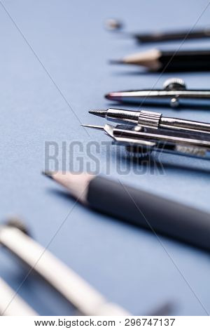 The Compass, Along With Other Tools For Drawing On The Blue Background