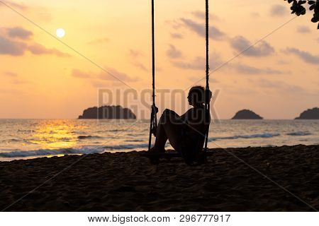 Travel Blog Photo: Silhouette Of A Woman In A Dress During Sunset With A View Over Sea With A Small 