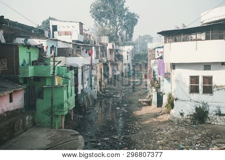 A Stinking Sewage Flow In The Slums. Poor Area Of Haridwar, India. House Poor People On The Hillside