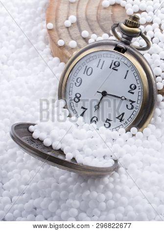 Retro Pocket Watch On White Polystyrene Balls