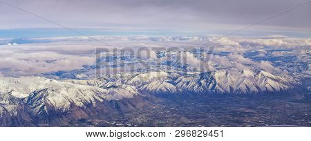 Aerial View From Airplane Of The Wasatch Front Rocky Mountain Range With Snow Capped Peaks In Winter