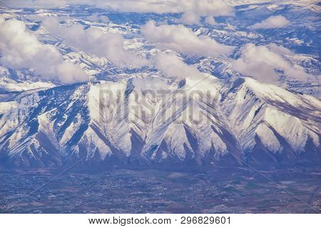 Aerial View From Airplane Of The Wasatch Front Rocky Mountain Range With Snow Capped Peaks In Winter
