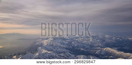 Aerial View From Airplane Of The Wasatch Front Rocky Mountain Range With Snow Capped Peaks In Winter