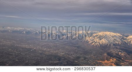 Aerial View From Airplane Of The Wasatch Front Rocky Mountain Range With Snow Capped Peaks In Winter