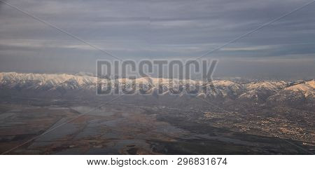Aerial View From Airplane Of The Wasatch Front Rocky Mountain Range With Snow Capped Peaks In Winter