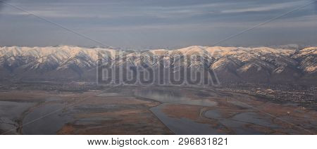Aerial View From Airplane Of The Wasatch Front Rocky Mountain Range With Snow Capped Peaks In Winter
