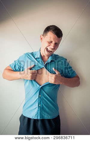 Businessman Tearing Off His Shirt And Showing Mucular Body Concept On Background