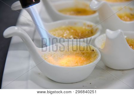 A Cream Brûlée In A White Spoon