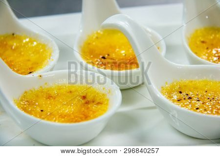 A Cream Brûlée In A White Spoon