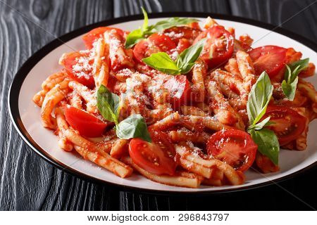 Italian Cuisine, Classic Pasta Recipe With Tomato Sauce, Parmesan Cheese And Basil Close-up On A Pla