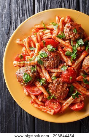 Pasta Casarecce Recipe With Meat Balls, Herbs And Cheese In Tomato Sauce Closeup On A Plate. Vertica