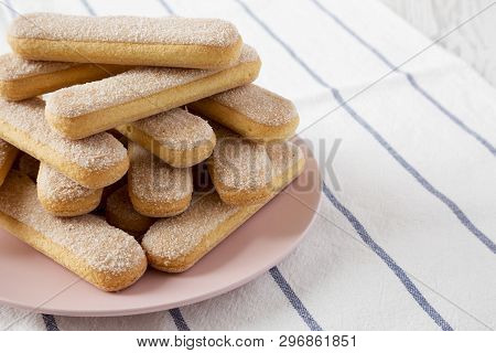 Savoiardi Or Ladyfingers Cookies On Pink Plate On Cloth, Low Angle View. Close-up. Copy Space.
