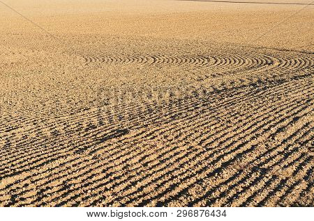 View Over Agricultural Field With Plugh Furrows In Order To Be Sown