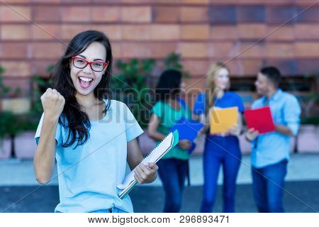 Cheering Nerdy German Female Student With Group Of Students Outdoor In The Summer In The City