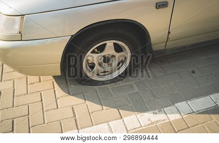 Car With Deflated Wheel On Street
Oldcar With Deflated Wheel Parked On Paved Street In Sunlight