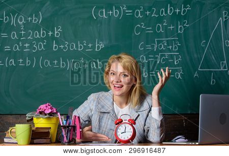 Teacher With Alarm Clock At Blackboard. Back To School. Teachers Day. Study And Education. Modern Sc