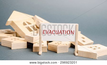 A Poster With The Words Evacuation And Fallen Wooden Houses. Removal Of People, Institutions, Proper