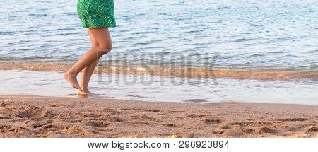 Leg Of Woman Running On Sand Beach. Summer Vacation. Happy Beautiful Woman Running On The Beach