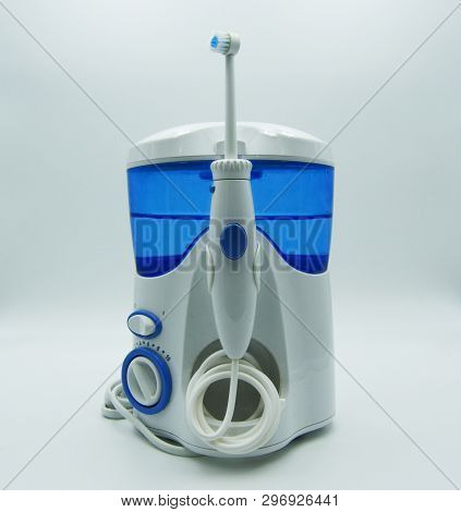 Irrigator And Electric Toothbrush On White Background