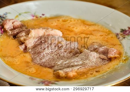 Preparing Tasty Homemade Chicken Leg Meat Schnitzel In Flour Diping In Mixed Egg