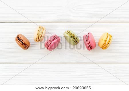 Brignt Macarons For Sweet Break On White Wooden Background Top View Mock Up